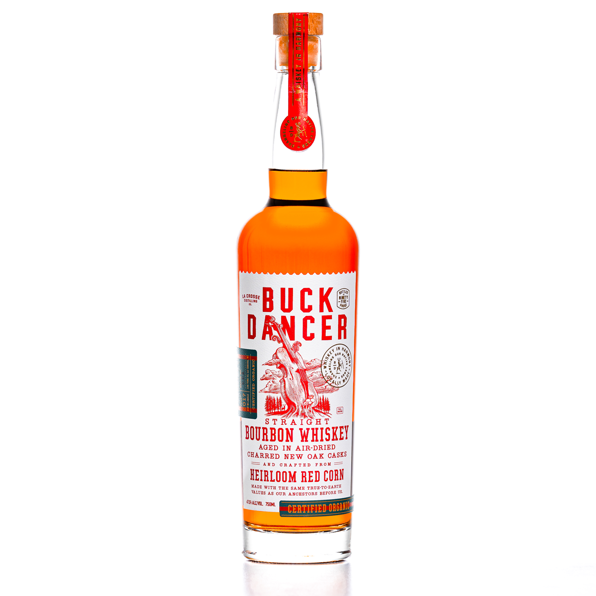Bottle of Buck Dancer straight bourbon whiskey with red and white label, cork stopper, and orange-tinted liquid inside.