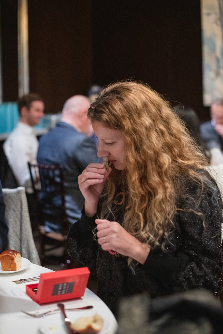 A guest attempts to identify a scent by using a wine aroma kit