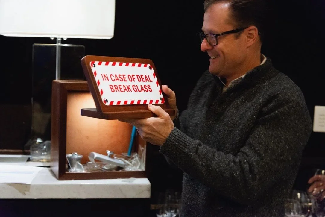 "In Case of Deal, Break Glass" the sign says. A deal was done and the economic buyer put his first through the Hollywood breakaway glass to access a fountain pen, inkwell, and blotter for a wet signature.