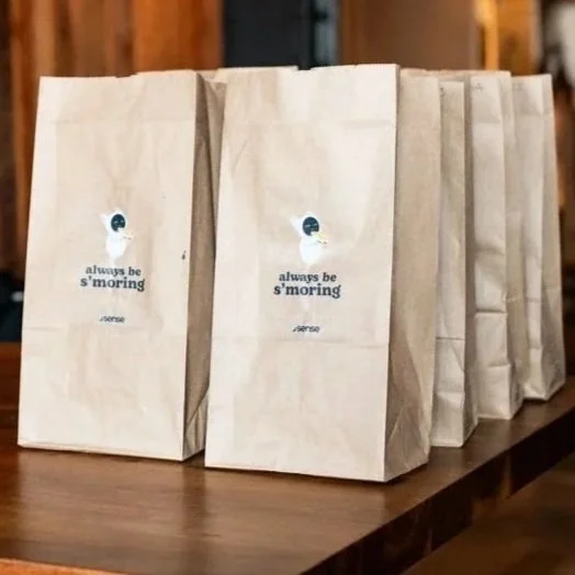 Goodie bags lined up with a branded sticker