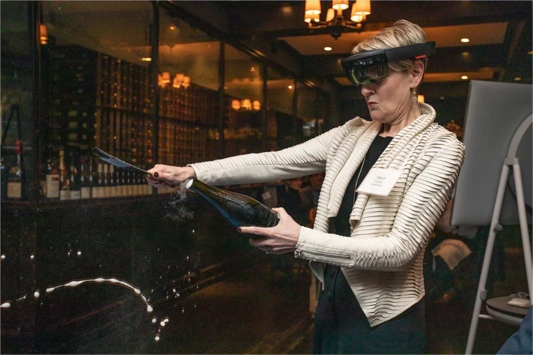 A guest sabering Champagne after being given instructions via the Microsoft HoloLens 2 
