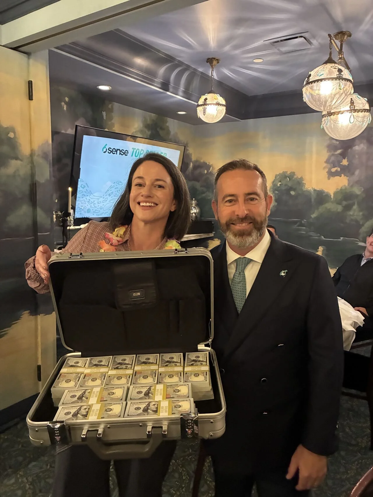Ami with the winner of a briefcase full of cash.