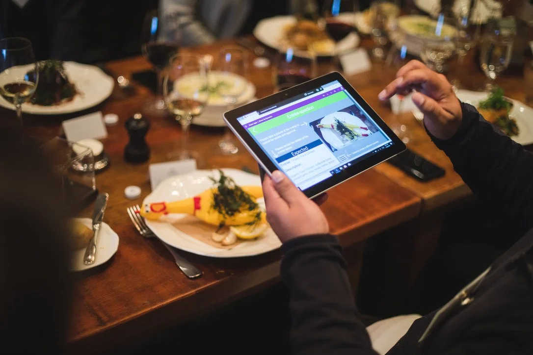A Microsoft Surface Tablet is running a custom Microsoft Power App integrated to Microsoft Dynamics Customer Service to help a guest with their entree