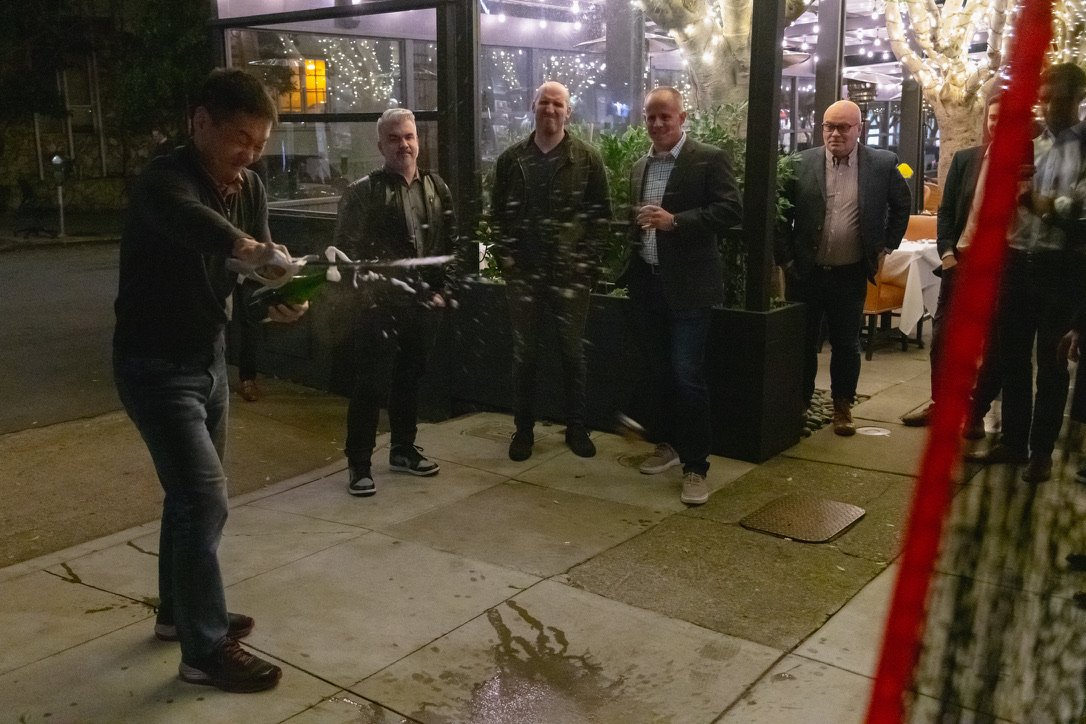 A guest sabering a bottle of Champagne successfully 