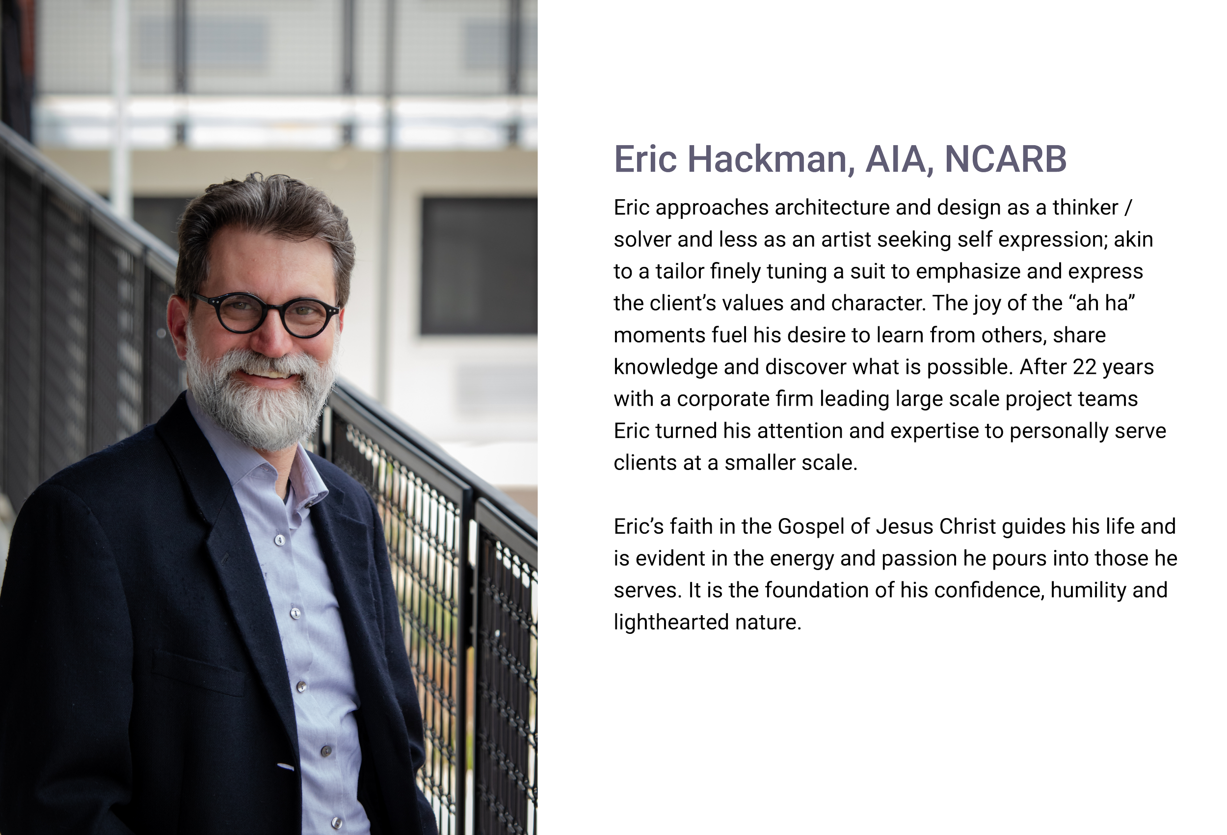 Eric Hackman of E.H. Goodman Architects.
A professional man with glasses and a gray beard, wearing a dark suit and light blue shirt, smiling while standing outdoors by a metal railing, with a modern building in the background.