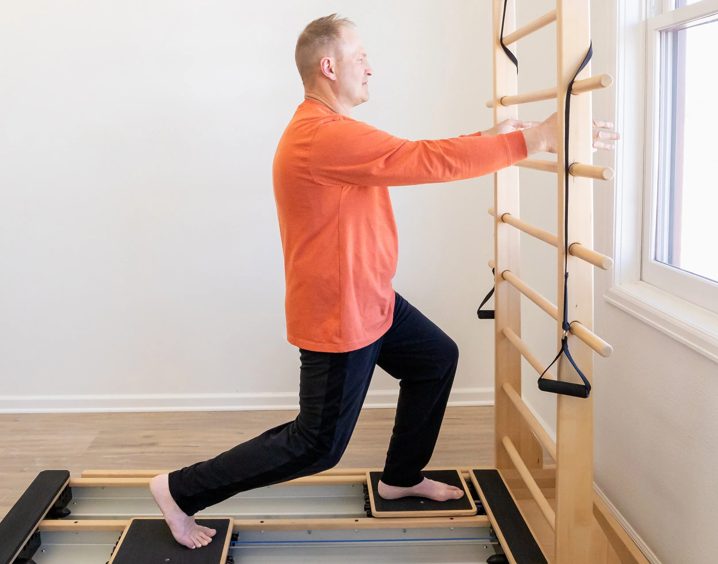 A Taylor Pilates & Fitness client working on the CoreAlign, an exercise and rehabilitation device that features a frame with two independent, smoothly moving carts on dual tracks.