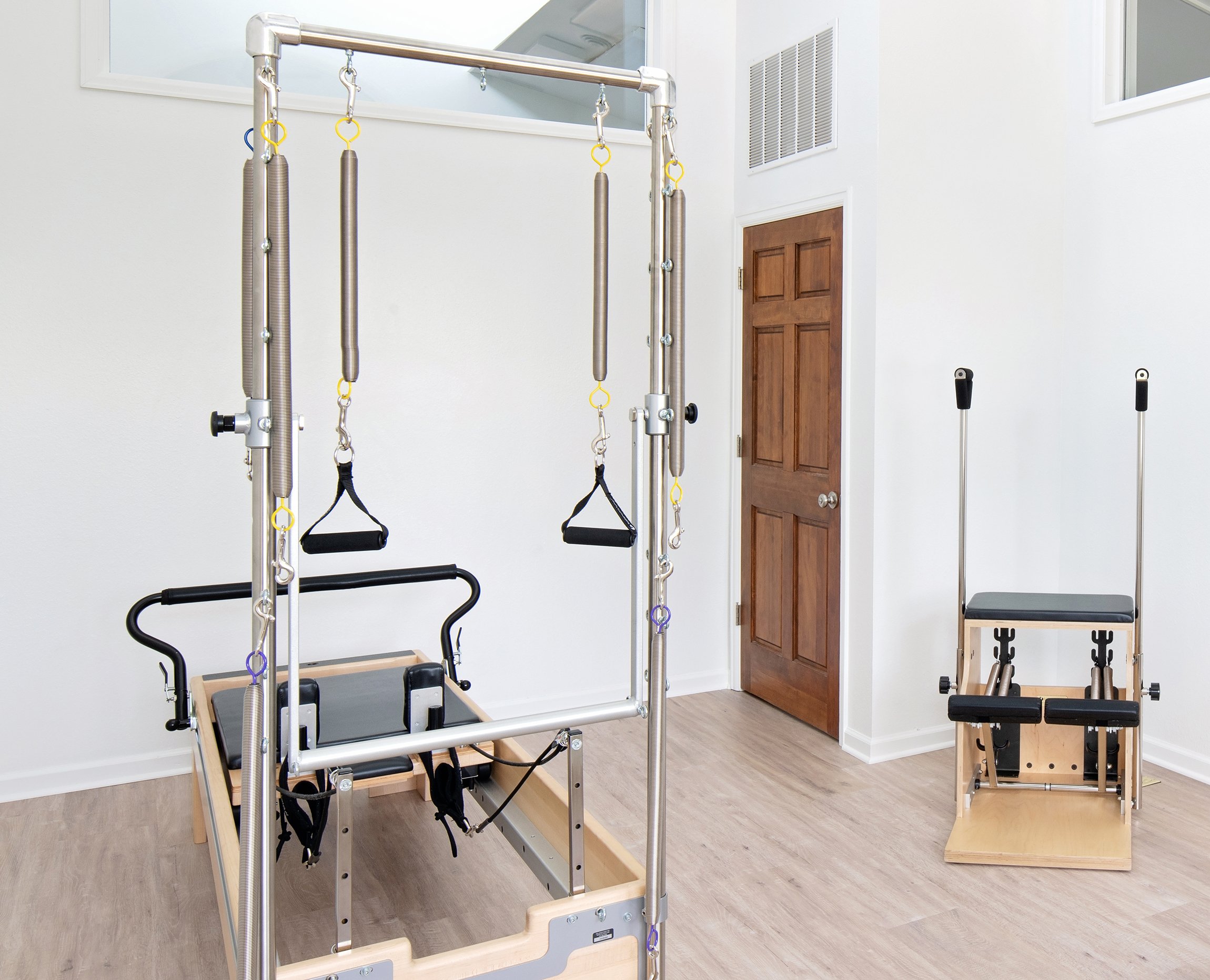 Taylor Pilates & Fitness studio image showing the many type of equipment used, including, the Wunda Chair, and Pilates Reformer.