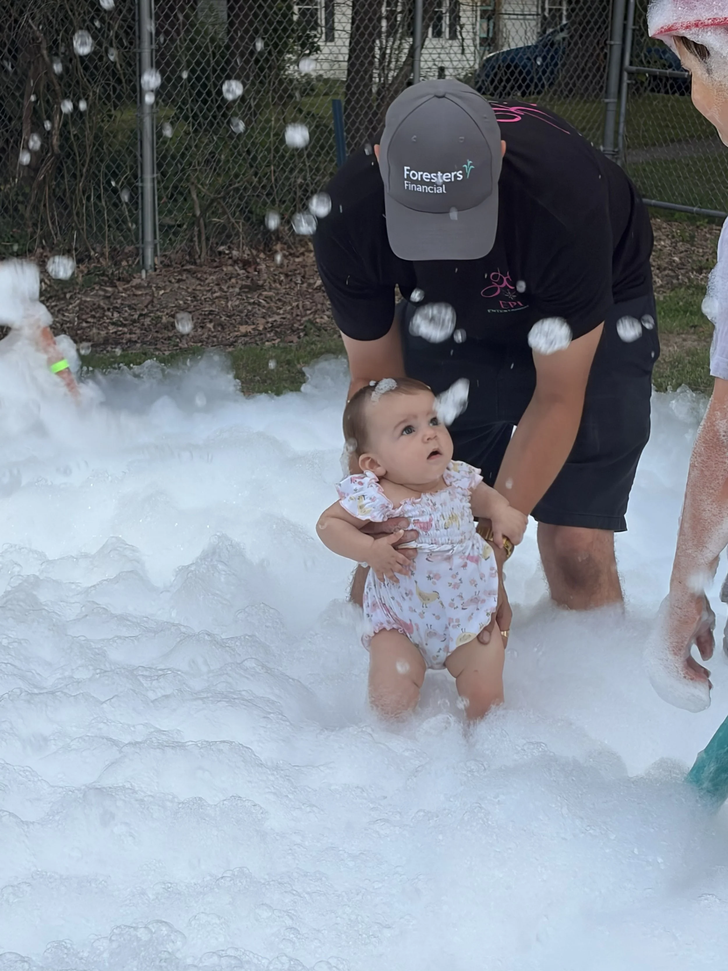 Father & his daughter playing in the foam for Father's Day
