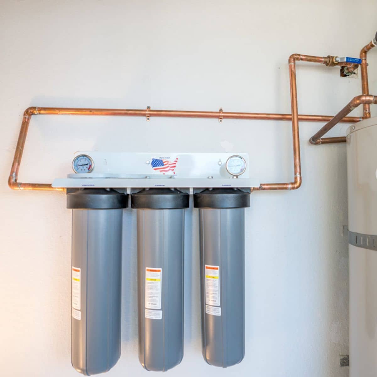 a water softener system mounted on a wall
