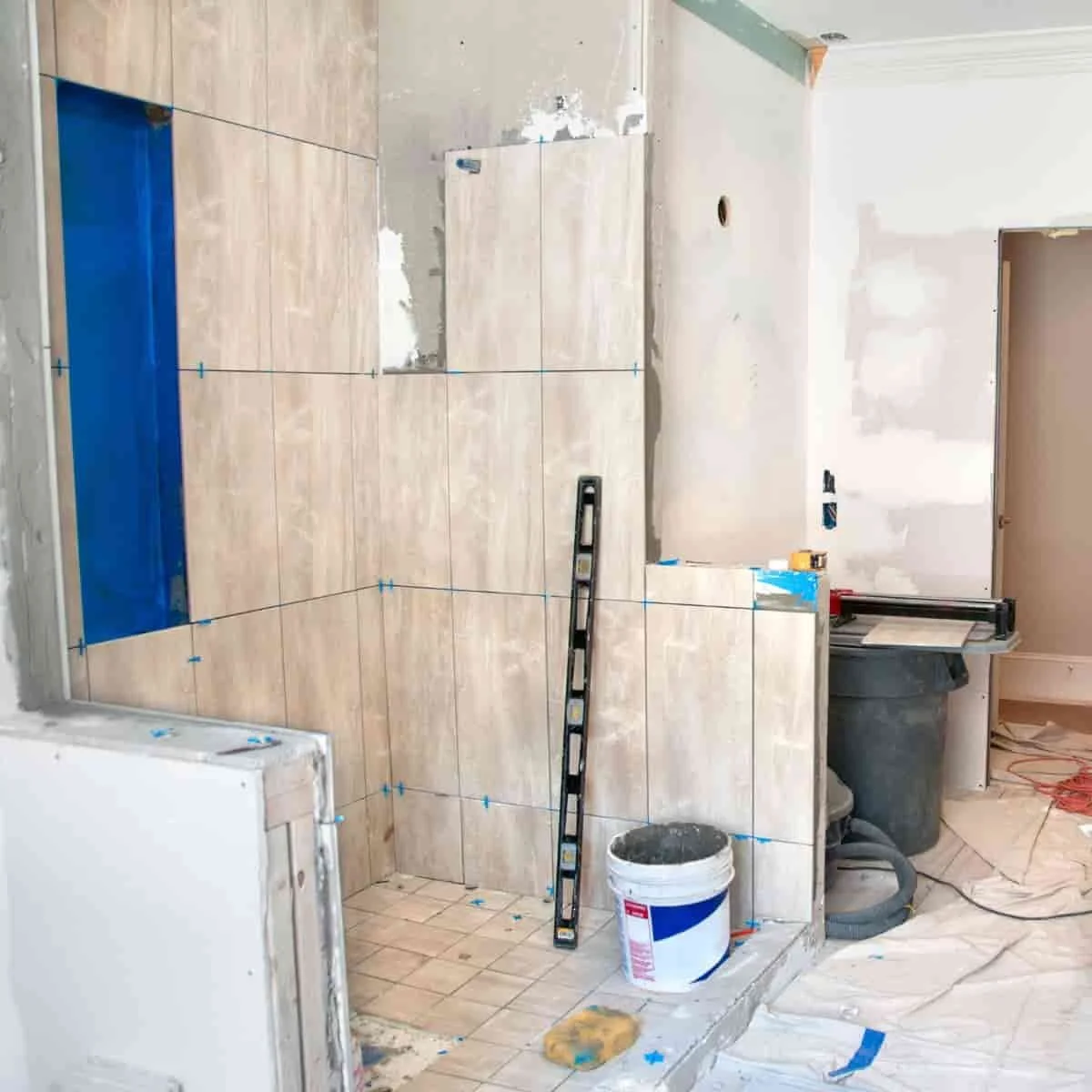 a bathroom remodel showing torn out plumbing fixtures and construction materials on the ground