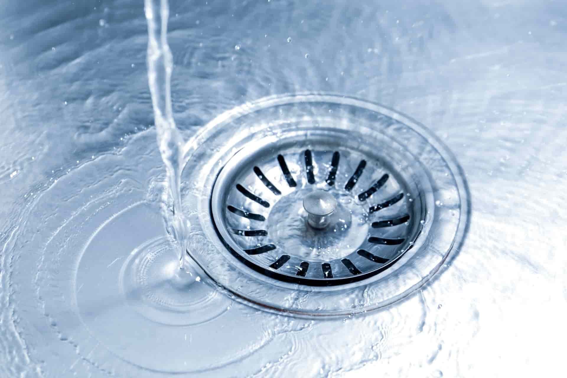 Kitchen sink drain with water flowing through it
