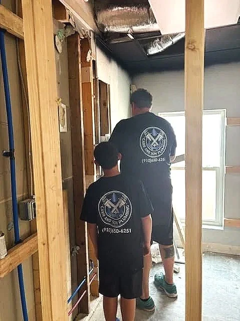 Alan Carr and son at a new construction plumbing installation