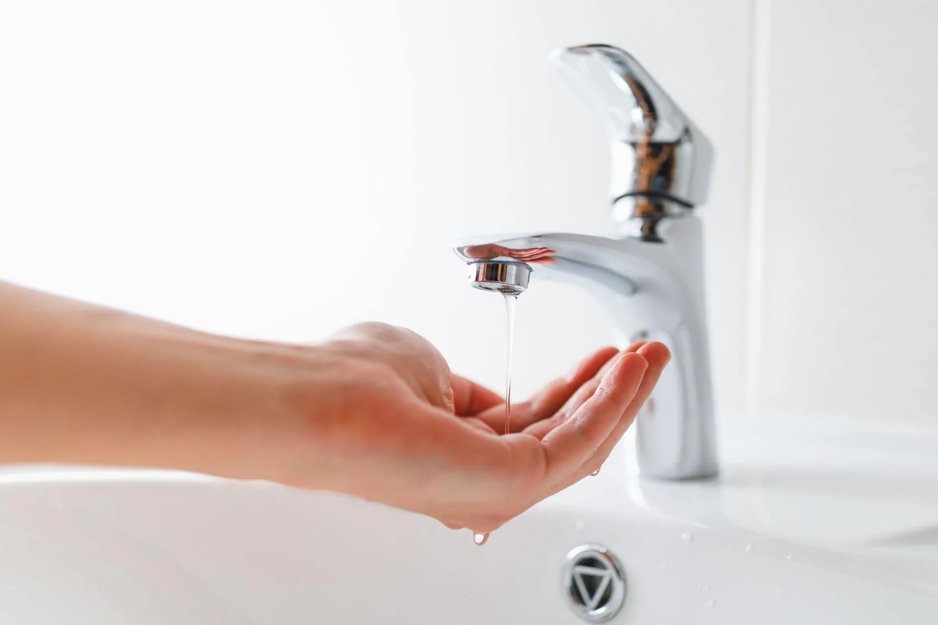 water slowly coming out of a sink into a hand