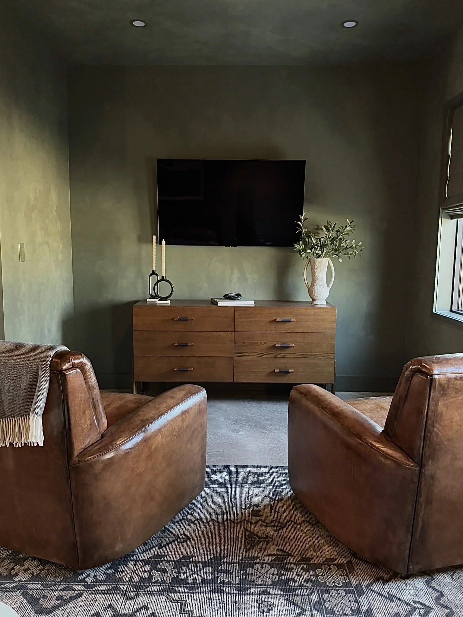 Modern industrial airplane hangar interior by H+Co Design Haus featuring rich textures, warm wood tones, masculine design details, and contemporary furnishings.