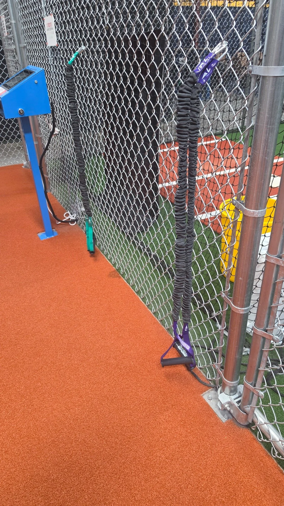 My green and purple ArmCare resistance cords at the training cages
