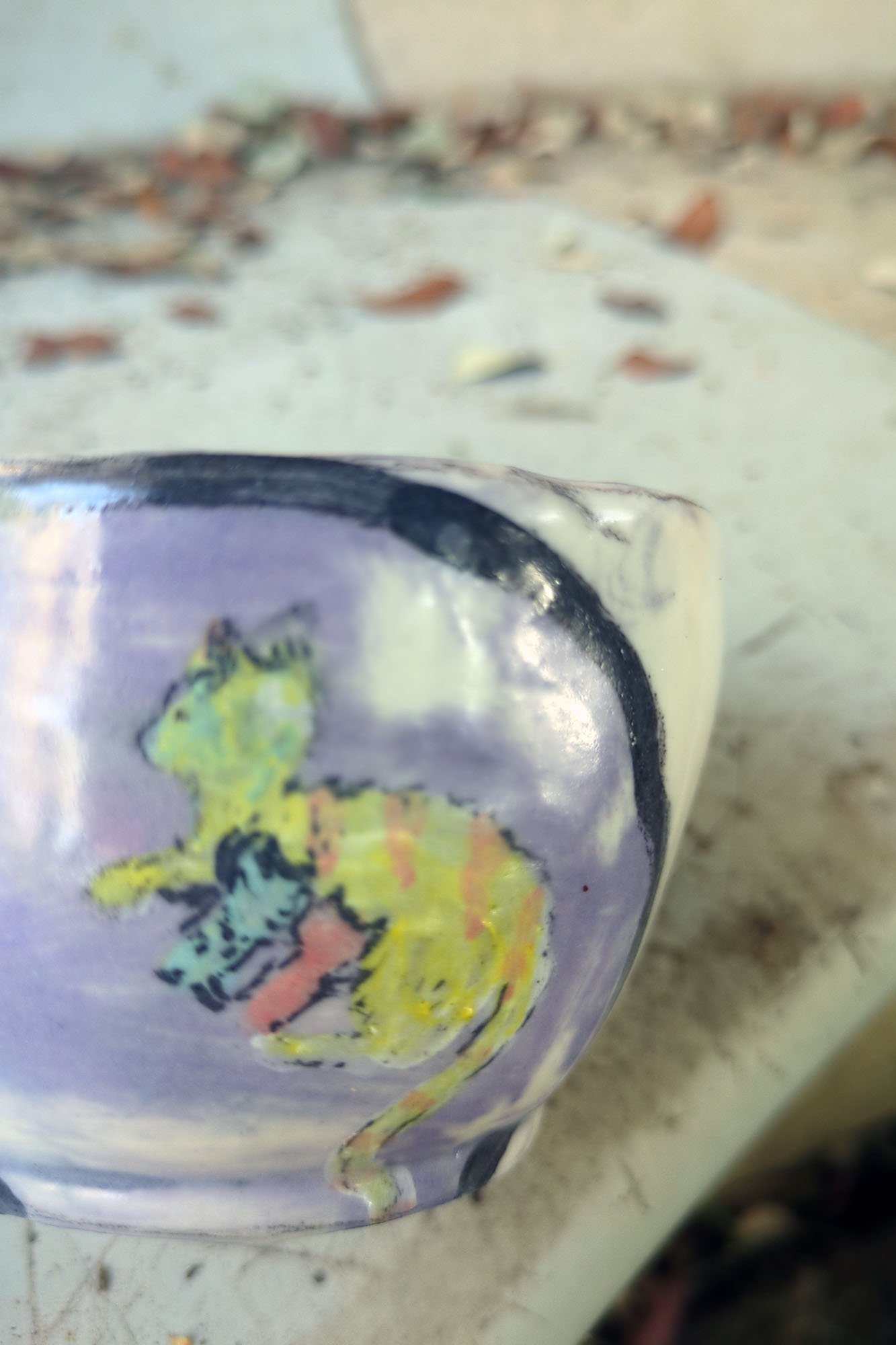 Close detail of painted kitten on lavender porcelain cup, painterly soft  glaze