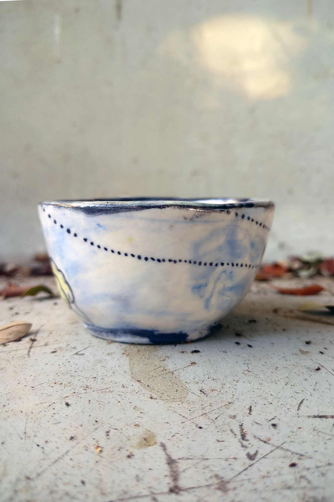 One of a kind ceramic cup by Johanna Jackson, side view showing dotted line detail on white and blue glaze (105 characters)