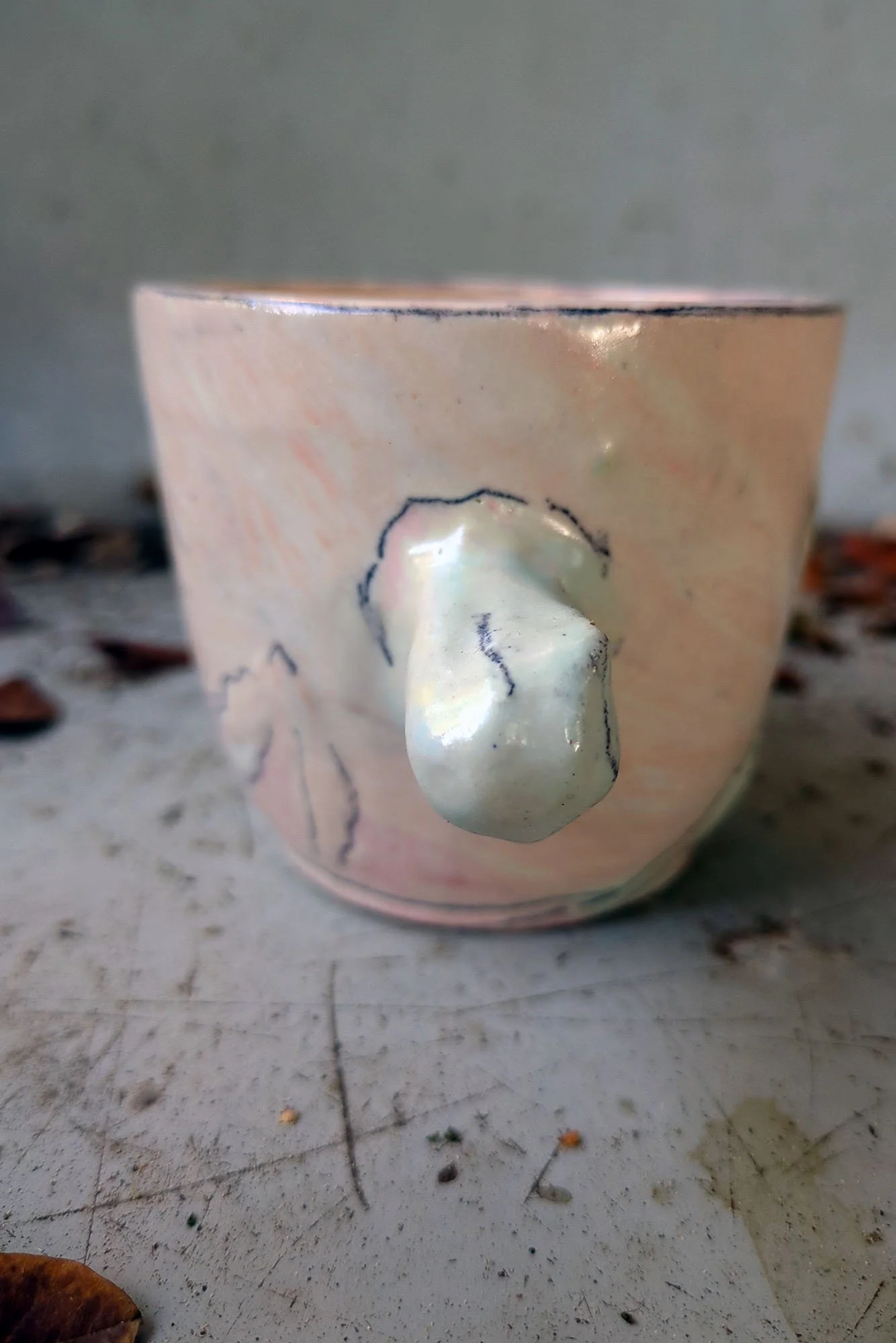 Johanna Jackson ceramic cup detail, raised white sculptural nub on warm pink porcelain with pencil drawn flower
