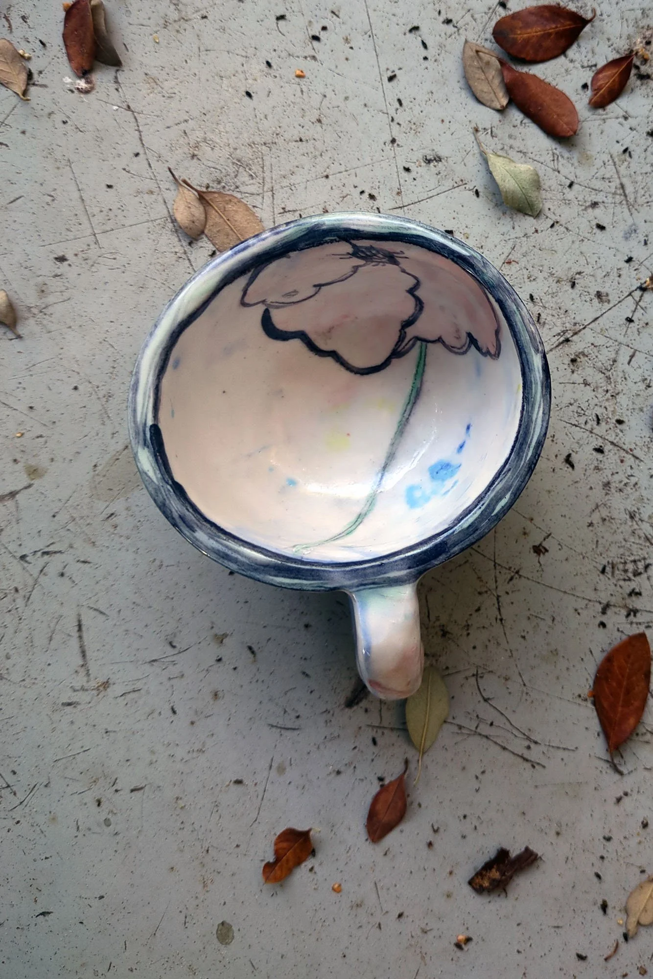 Looking down into one of a kind ceramic cup by Johanna Jackson, large pink flower painted on interior