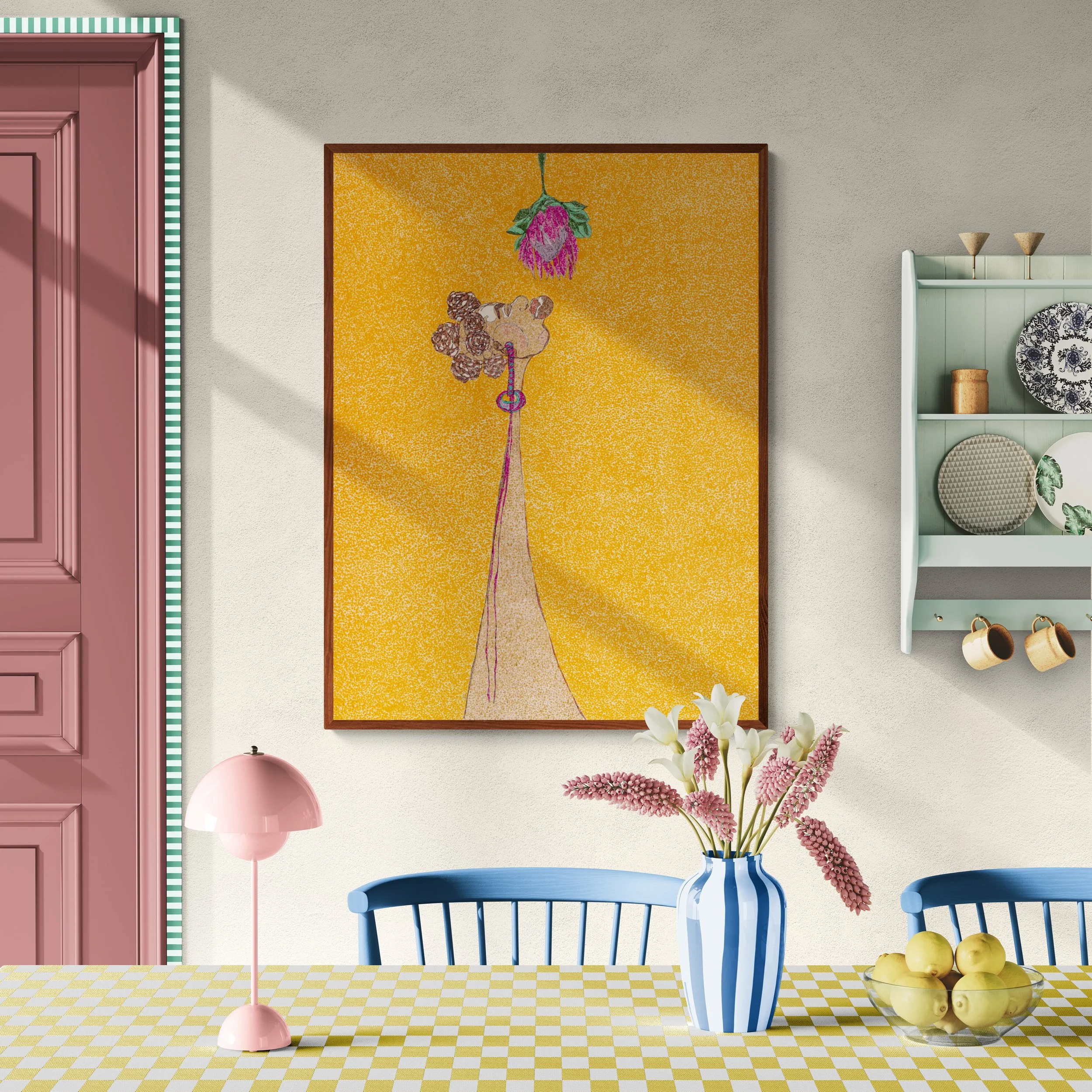 A living room with a pink door, a yellow checkered tablecloth, a pink lamp, a vase with pink and white flowers, a framed art piece of a giraffe and a flower, a white shelving unit with decorative items, a blue chair, and a bowl with lemons.