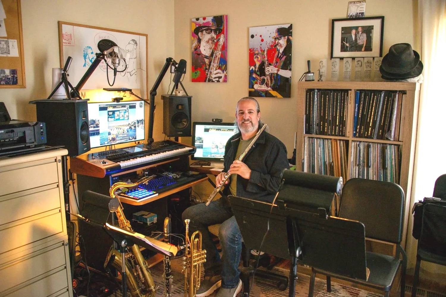 Todd Clickard in his music studio with his flute, keyboards, and wind instruments