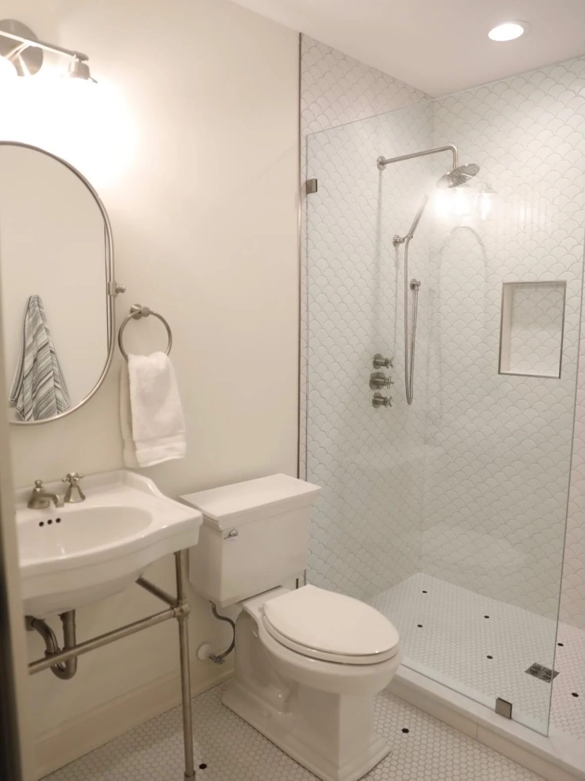 From laundry room to pool bath.
This once-utilitarian space was completely transformed into a bright, airy bathroom where pool guests can rinse off and change before heading inside. The white-and-bright design keeps the space feeling fresh and timele