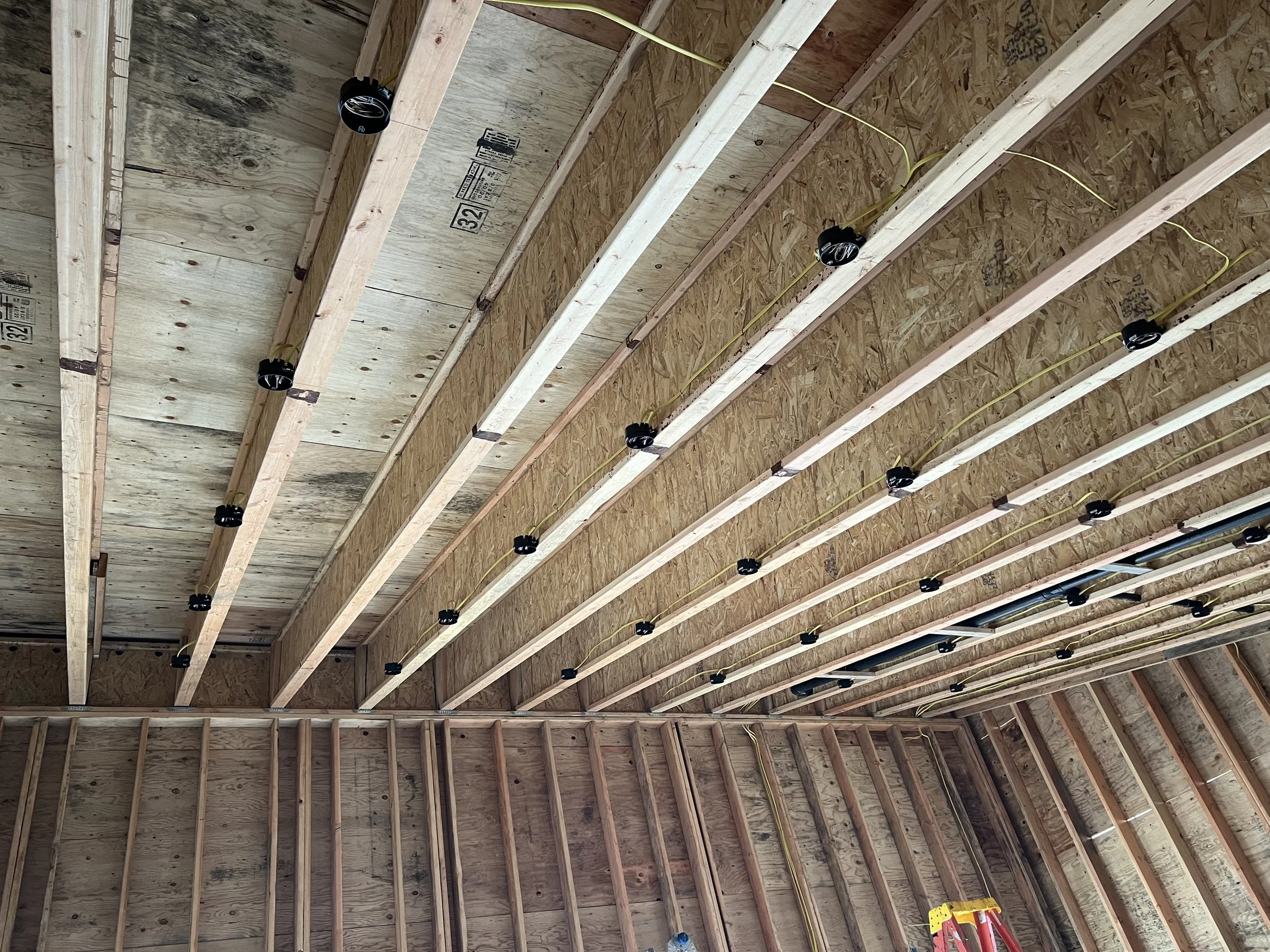 Electrical rough-in and lighting installation during construction
