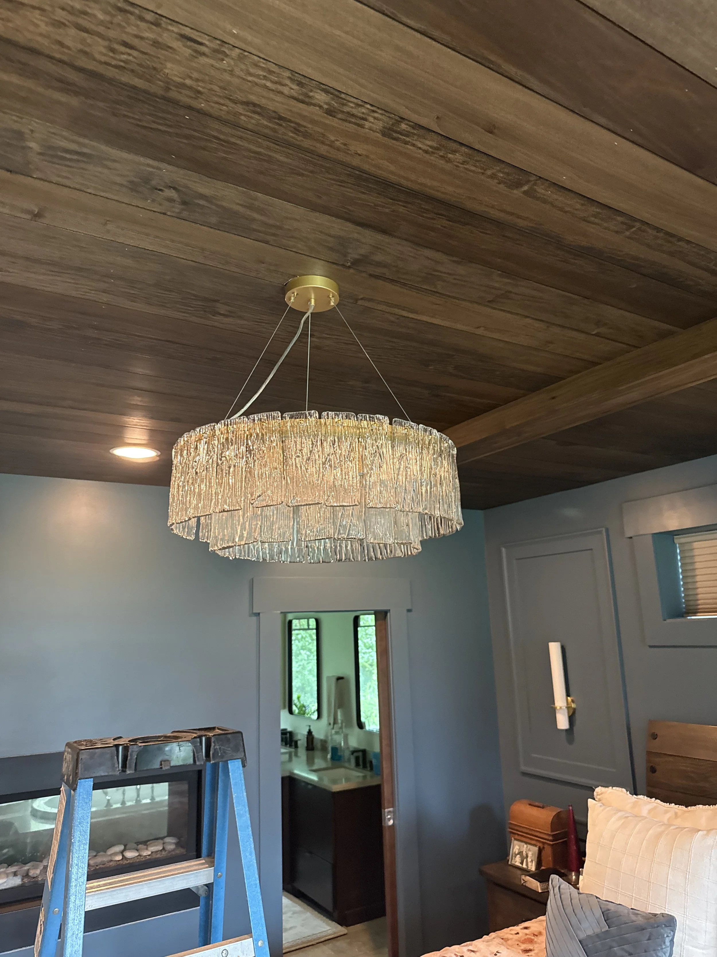 Custom chandelier installation in residential living room.