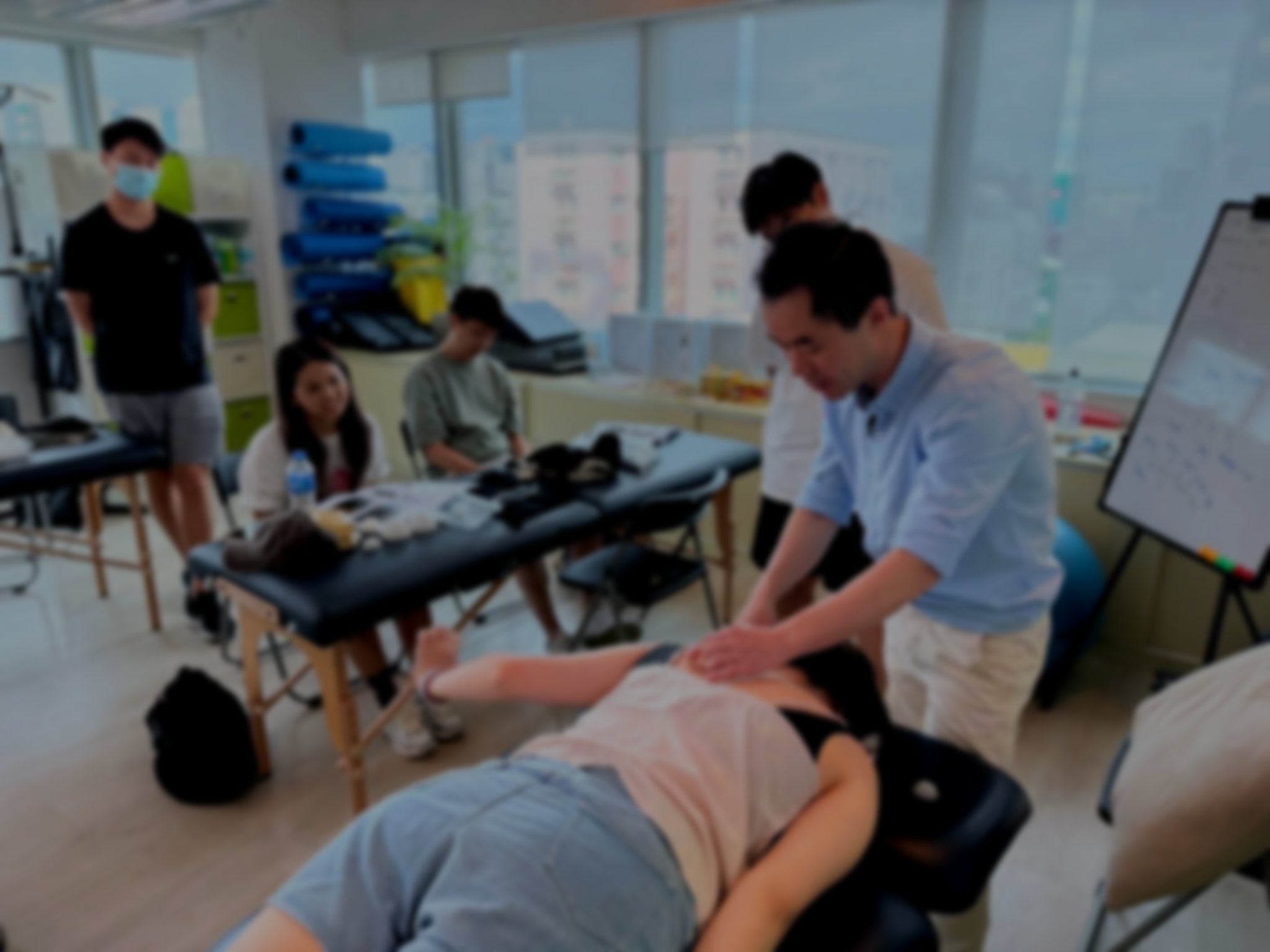 A big group of physiotherapist who joined Physio Kenny Yu for his fascial mobilisation workshop break down into small groups to practice the new manual technique they learned after a few minutes they can master the new skills and use on patients.