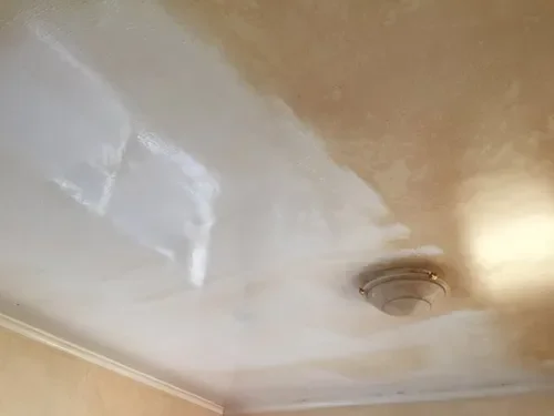 Ceiling clean with discolouration near the light fixture.