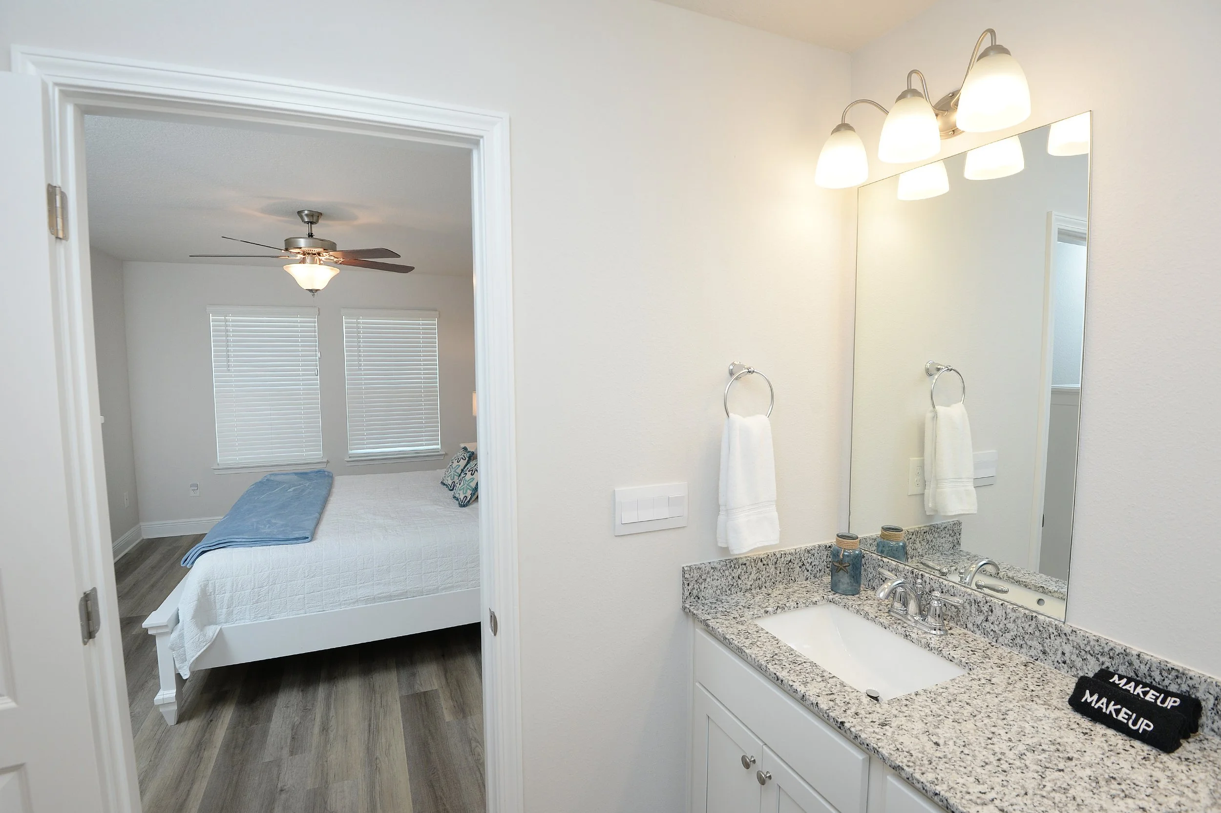 Master bathroom at Coastal Tide Escapes beach vacation home Panama City Beach, featuring double vanity with granite countertops and coastal tile