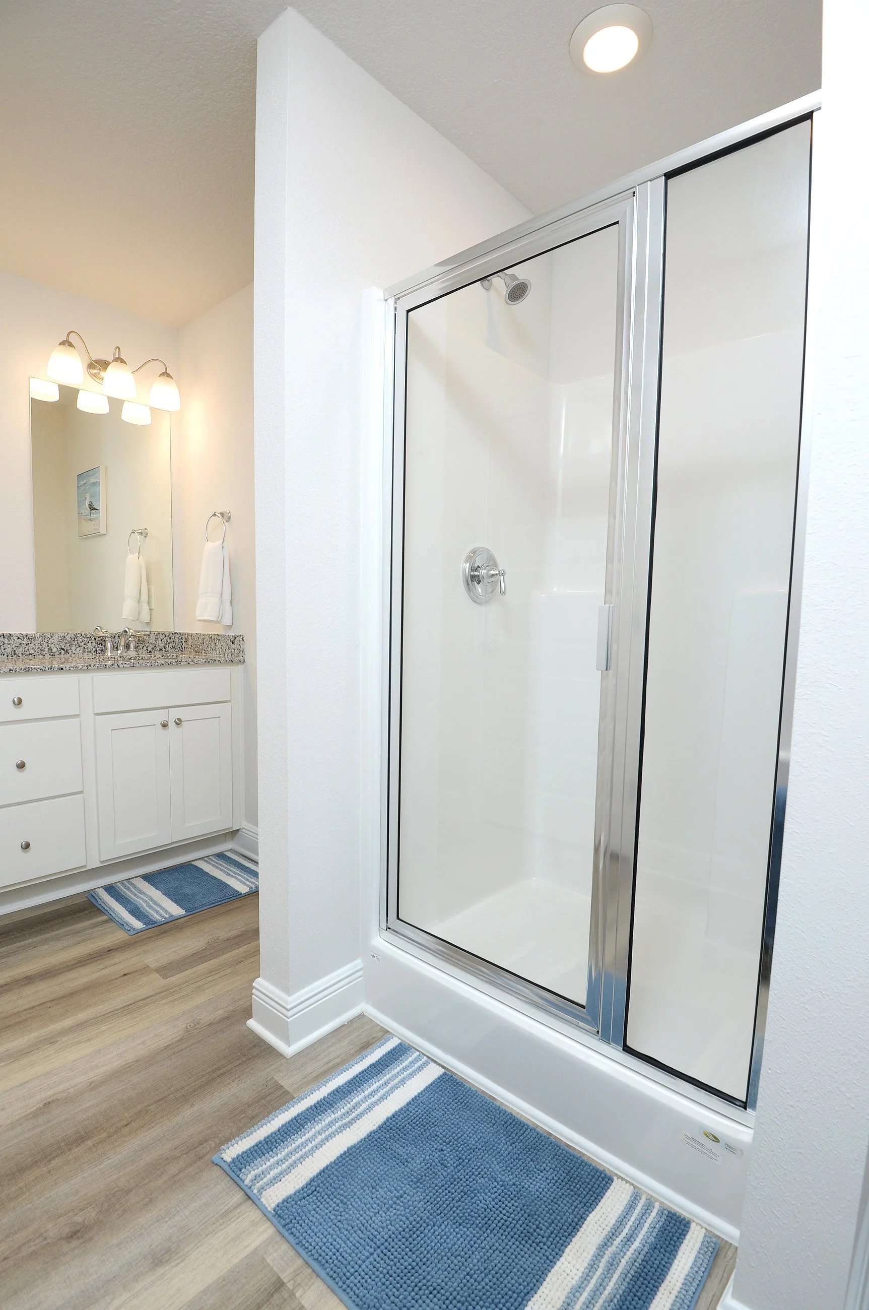 Walk-in glass shower in master bathroom at Coastal Tide Escapes Panama City Beach vacation home