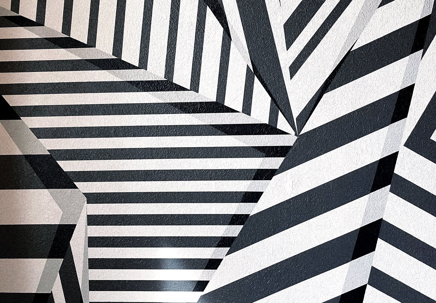 Black and white geometric mural with angular linework by Andrew Haan for a private residence