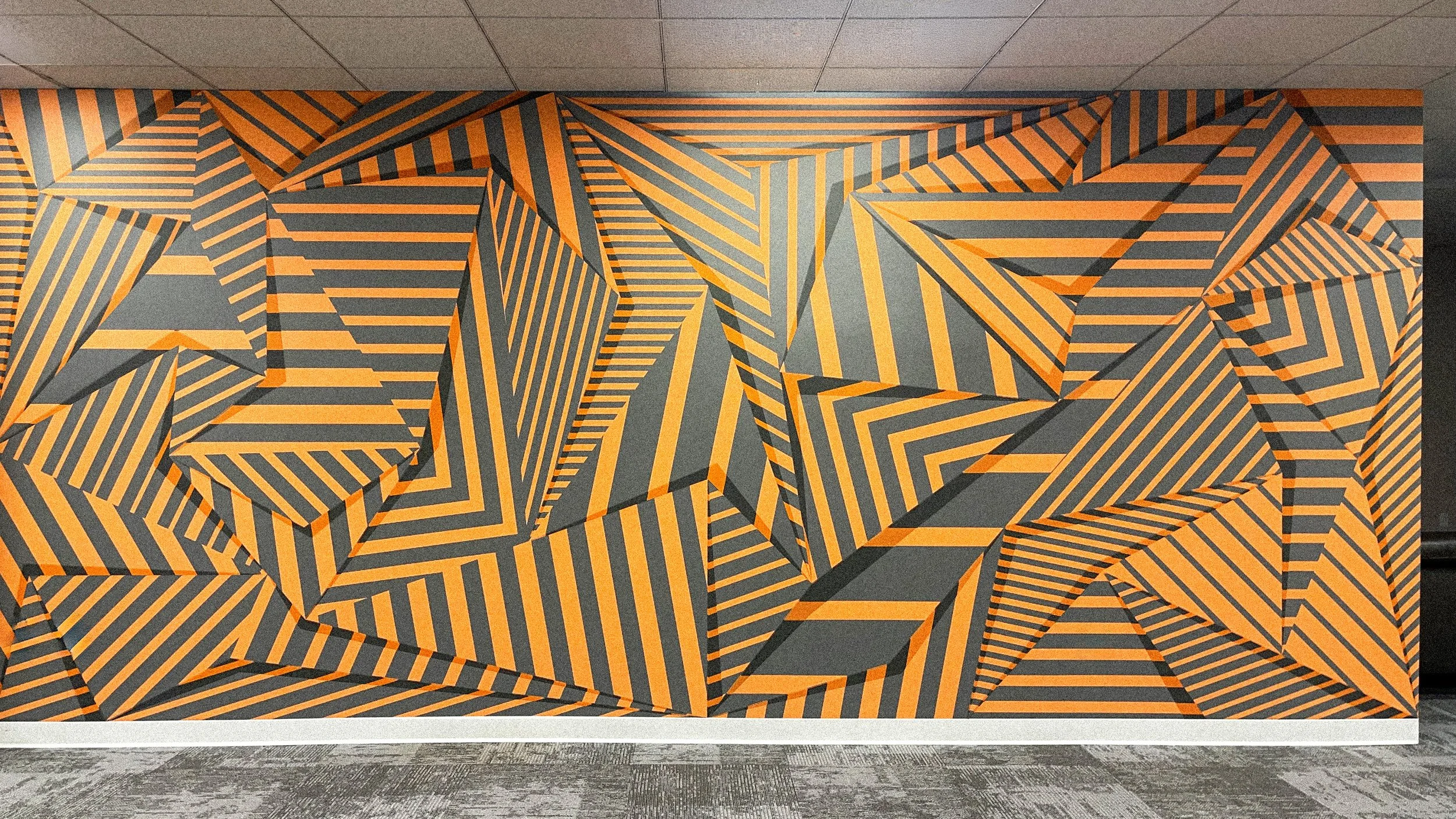 laguna-ca-andrew-haan-01.jpg Finished geometric mural in a private office in Laguna, California, featuring layered orange and charcoal striped forms that create an illusion of depth.