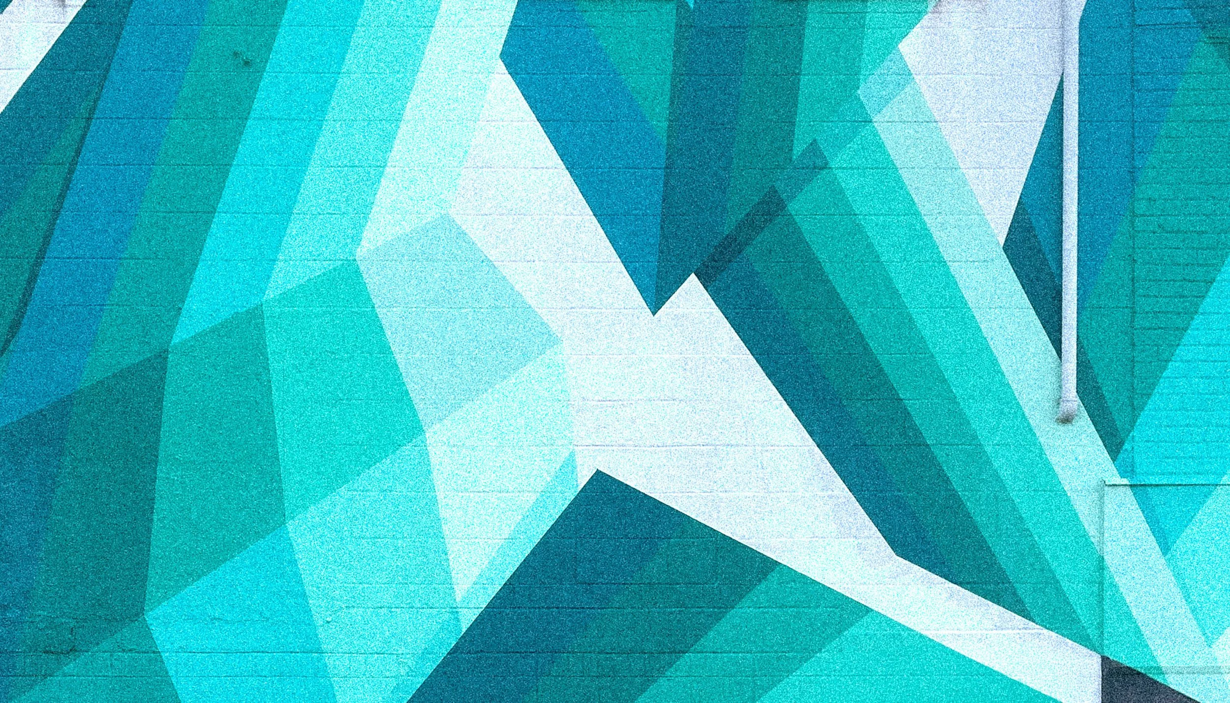 Geometric public art mural in teal and green by Andrew Haan in Endicott, New York