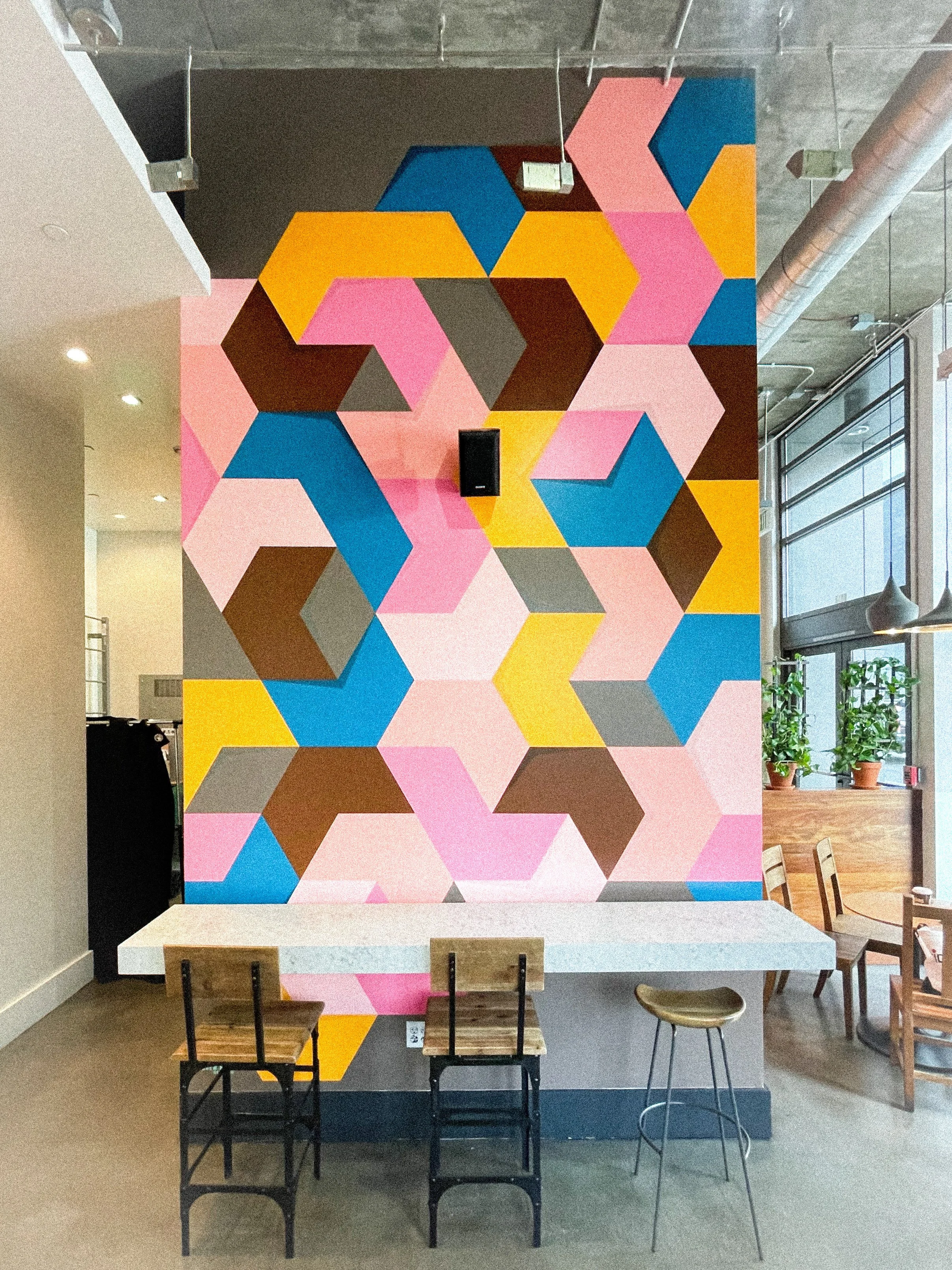 Colorful geometric mural by Andrew Haan inside Philz Coffee in Downtown Los Angeles.