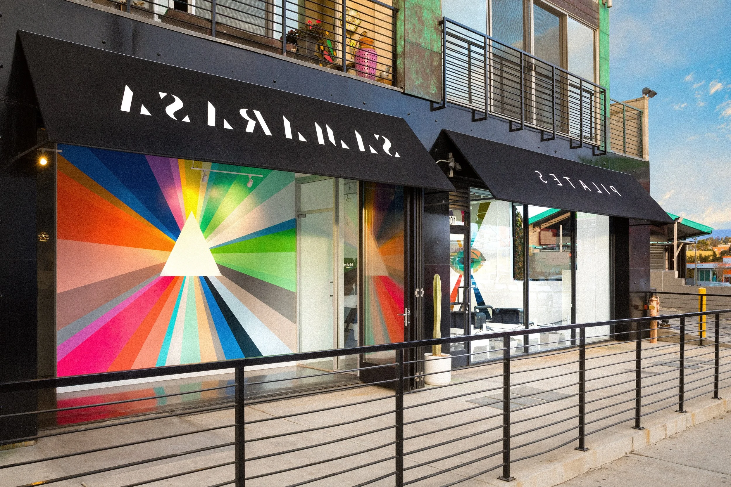 Exterior view of a colorful radiating mural at Samarasa Yoga Studio in Los Angeles.