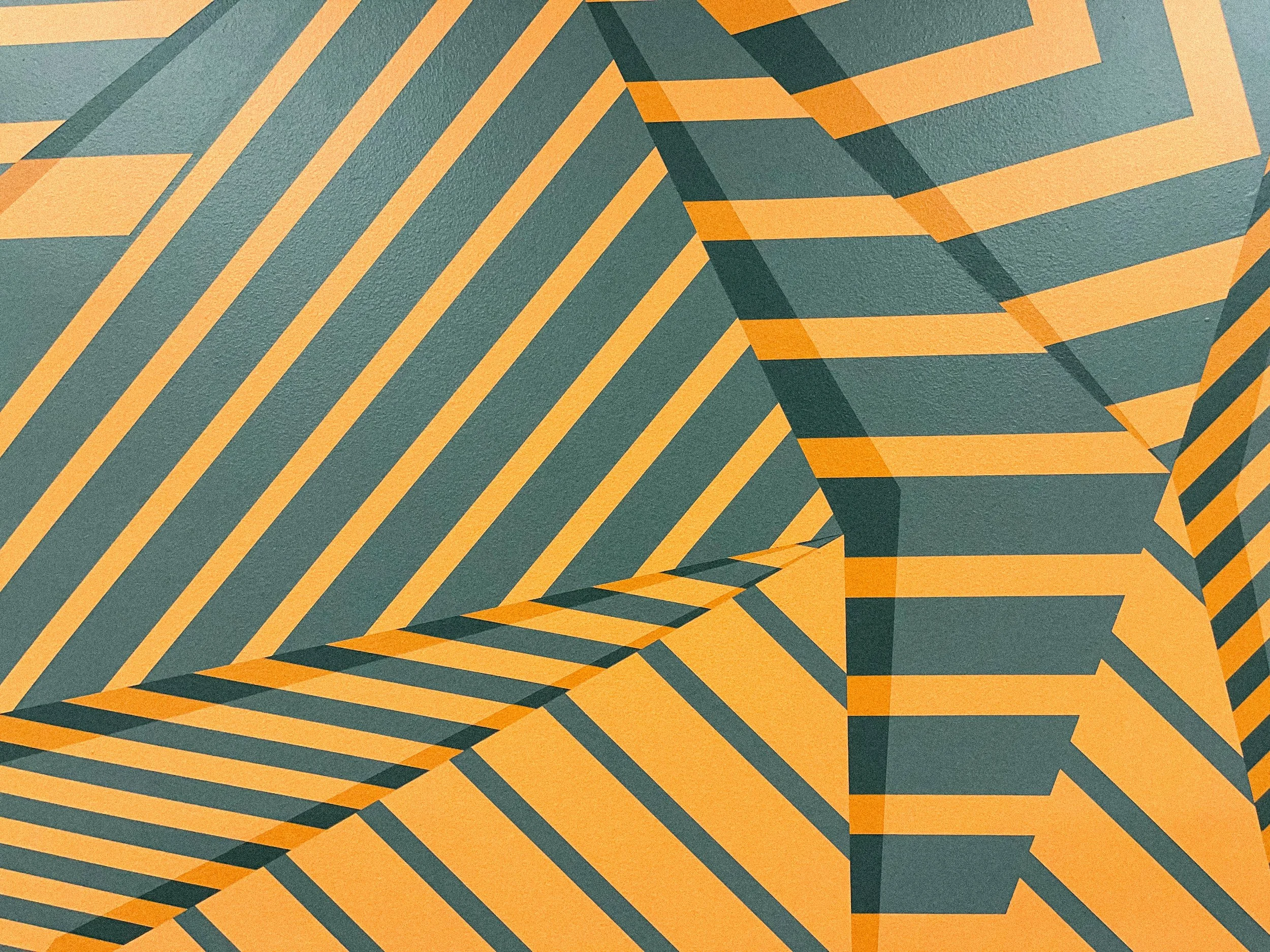 Close-up of layered geometric forms in the private office mural, using repeated orange and charcoal lines to create depth and movement.