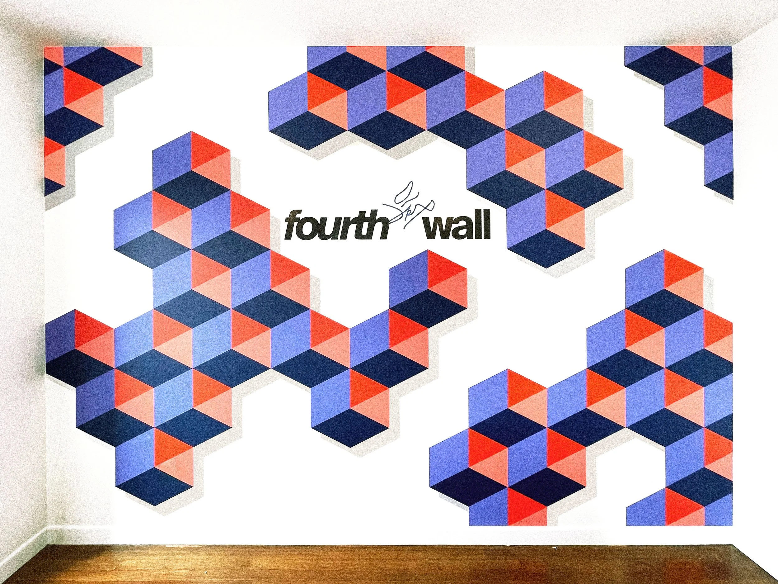 Bold striped mural wrapping around architectural corners inside the Fourthwall office in Venice, California.