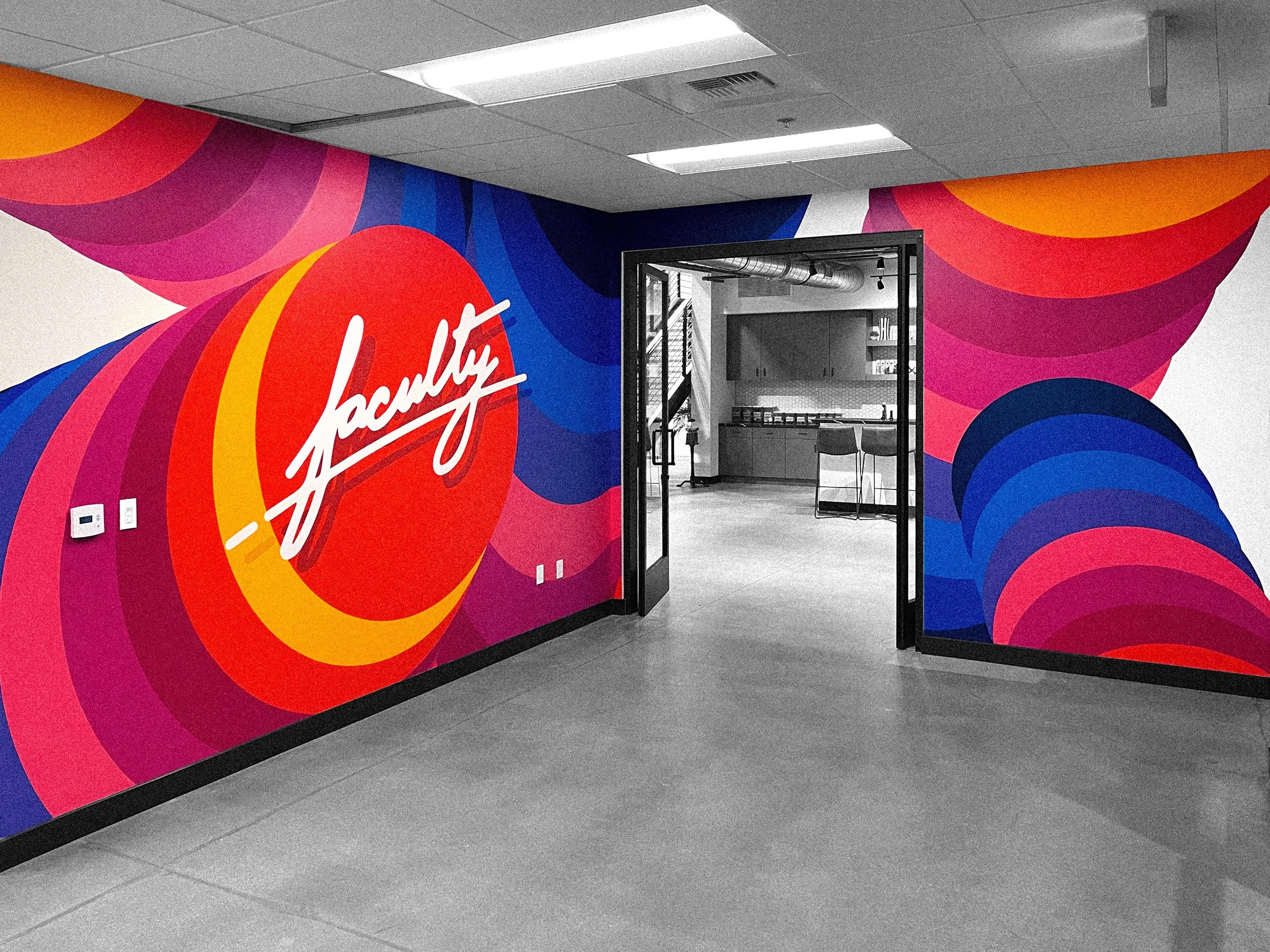 Finished Faculty Inc. mural by Andrew Haan featuring bold colorful forms and the company logo