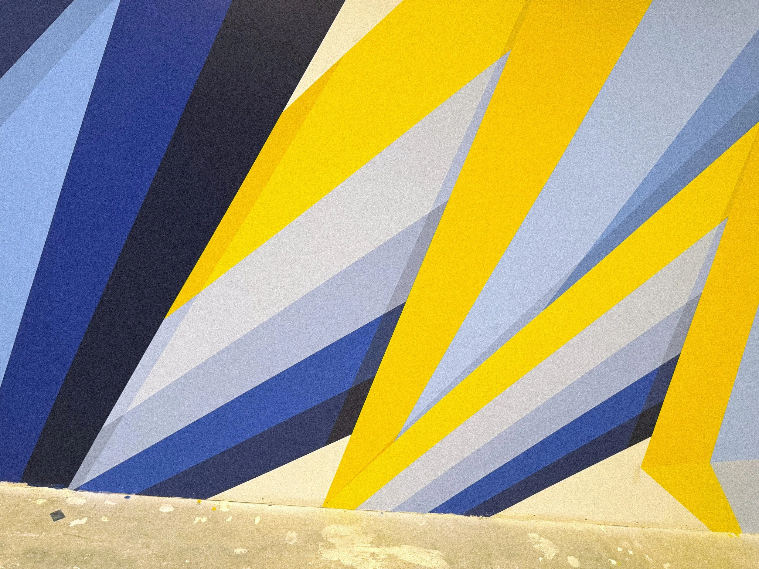 Site-specific geometric mural wrapping the interior walls of The MARK UCLA residential fitness center in Los Angeles.