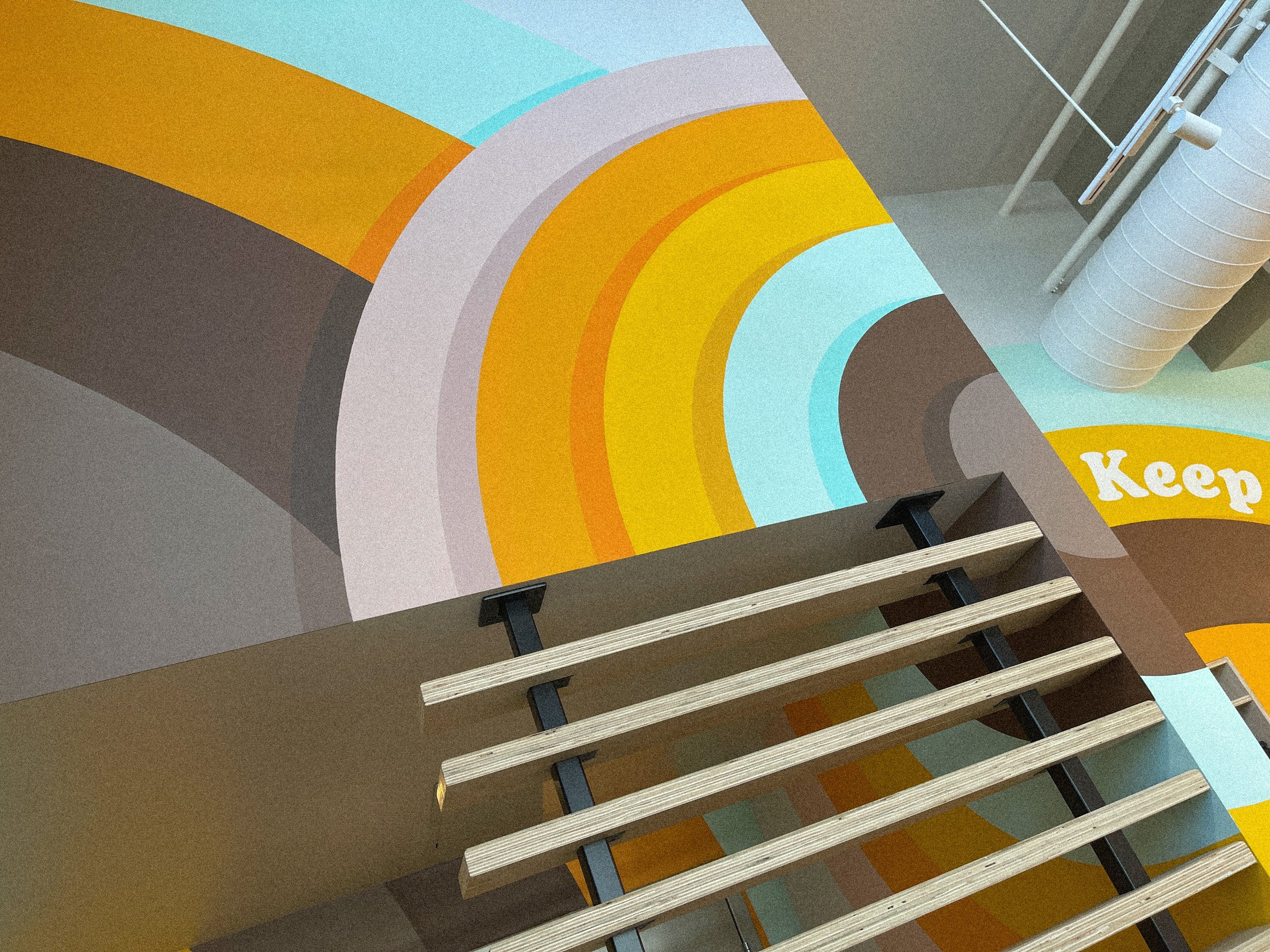 Detail of geometric mural wrapping the interior architecture at Philz Coffee in Calabasas