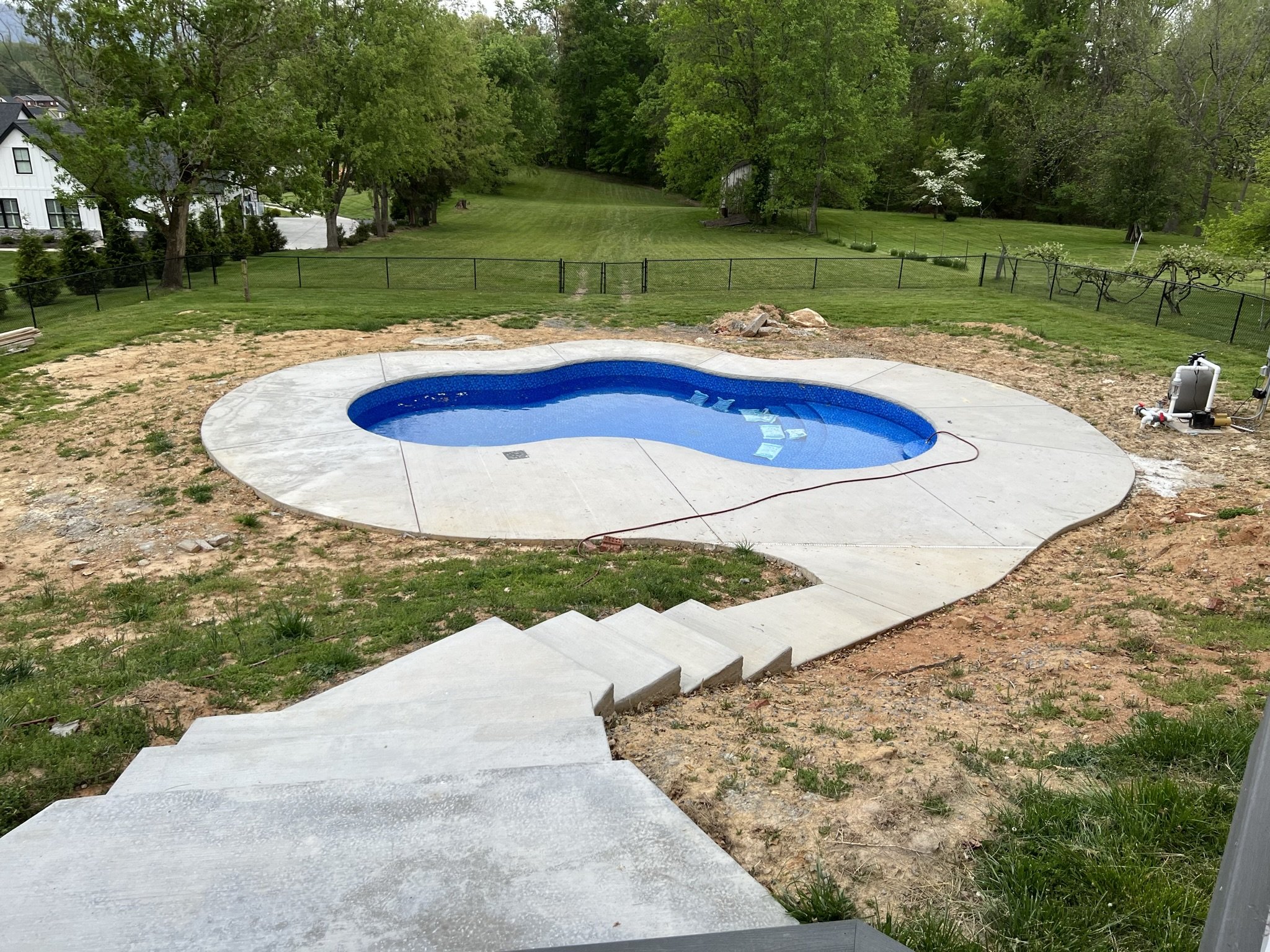 Before photo of a pool landscape project featuring grading, lawn installation, and backyard improvements by EarthWorks Landscaping LLC.