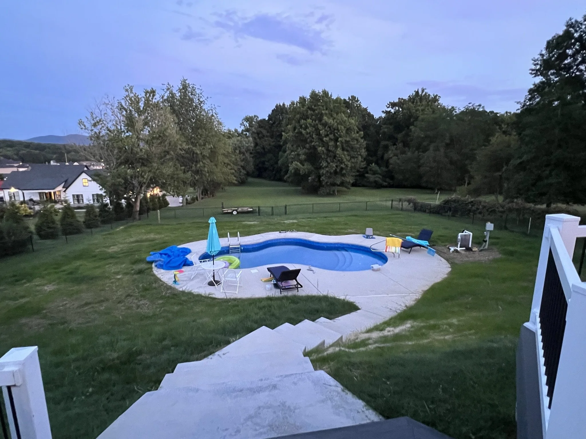 After photo of a pool landscape project featuring grading, lawn installation, and backyard improvements by EarthWorks Landscaping LLC.