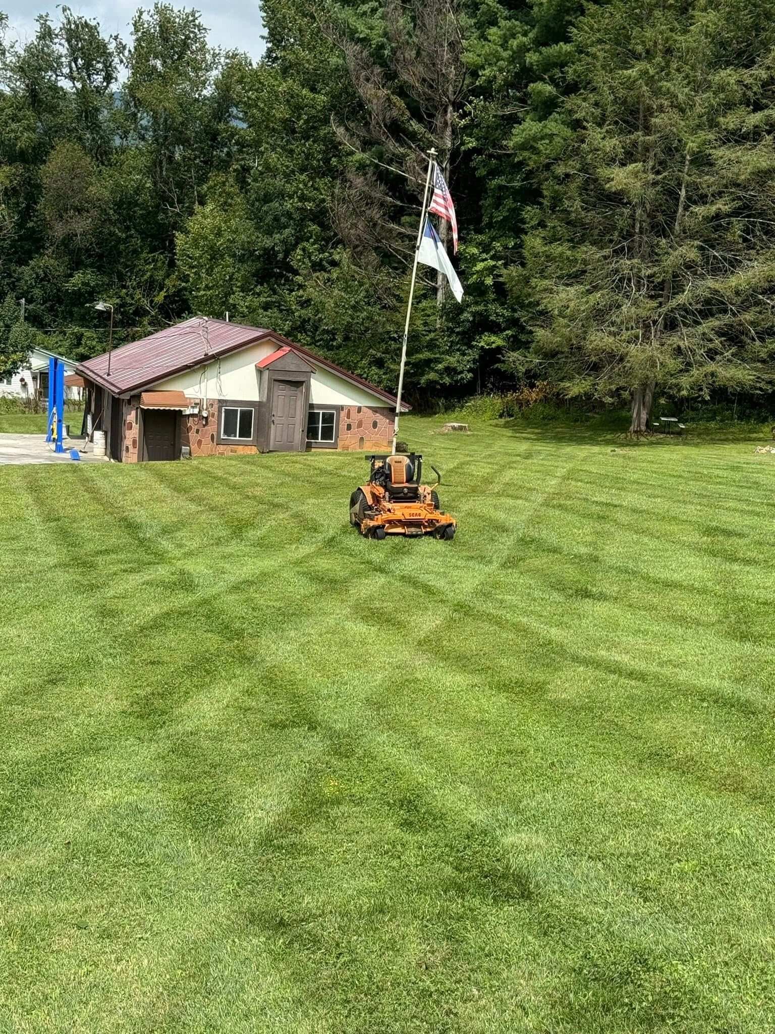 Freshly mowed lawn with professional striping completed by EarthWorks Landscaping as part of routine lawn maintenance services.
