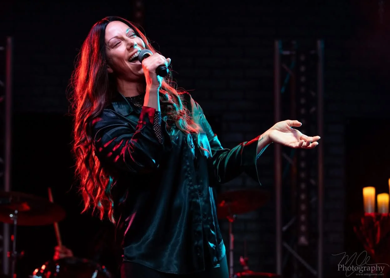 Sarah Moon as Alanis Morissette, performing at an Infatuation Junkie Live Performance.
