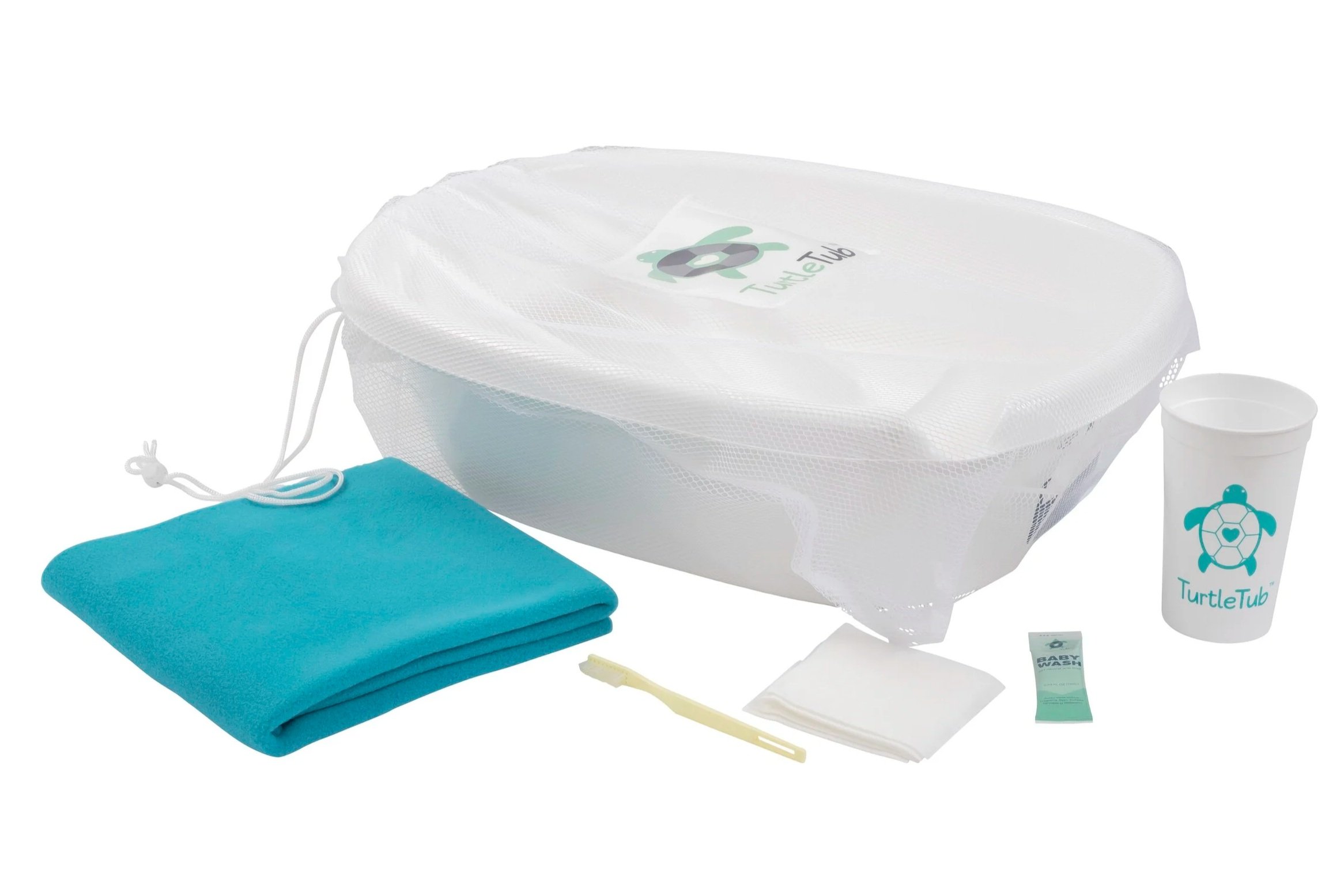 A collection of baby care items includes a white mesh drawstring bag with a turtle logo, a blue folded towel or blanket, a white cup with a turtle logo, a tube of baby wash, a yellow toothbrush, and a small packet of baby wipes.
