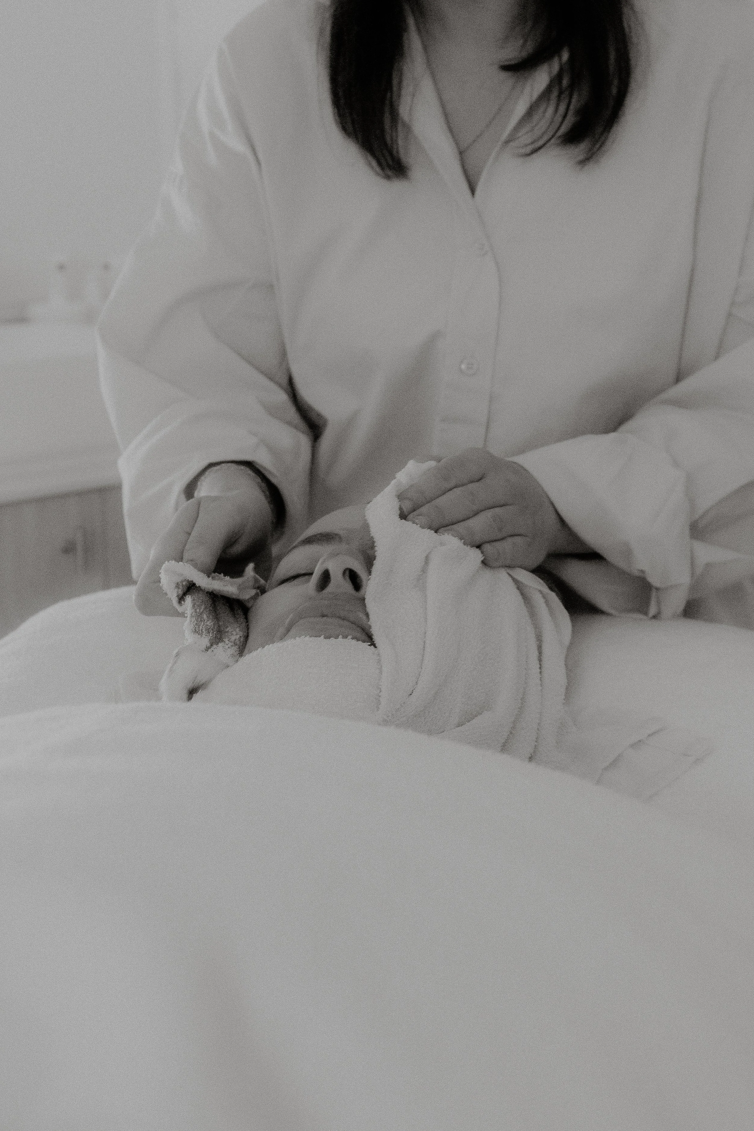 KIN Skin Co skin therapist applying a warm towel during a personalised facial treatment in Bendigo