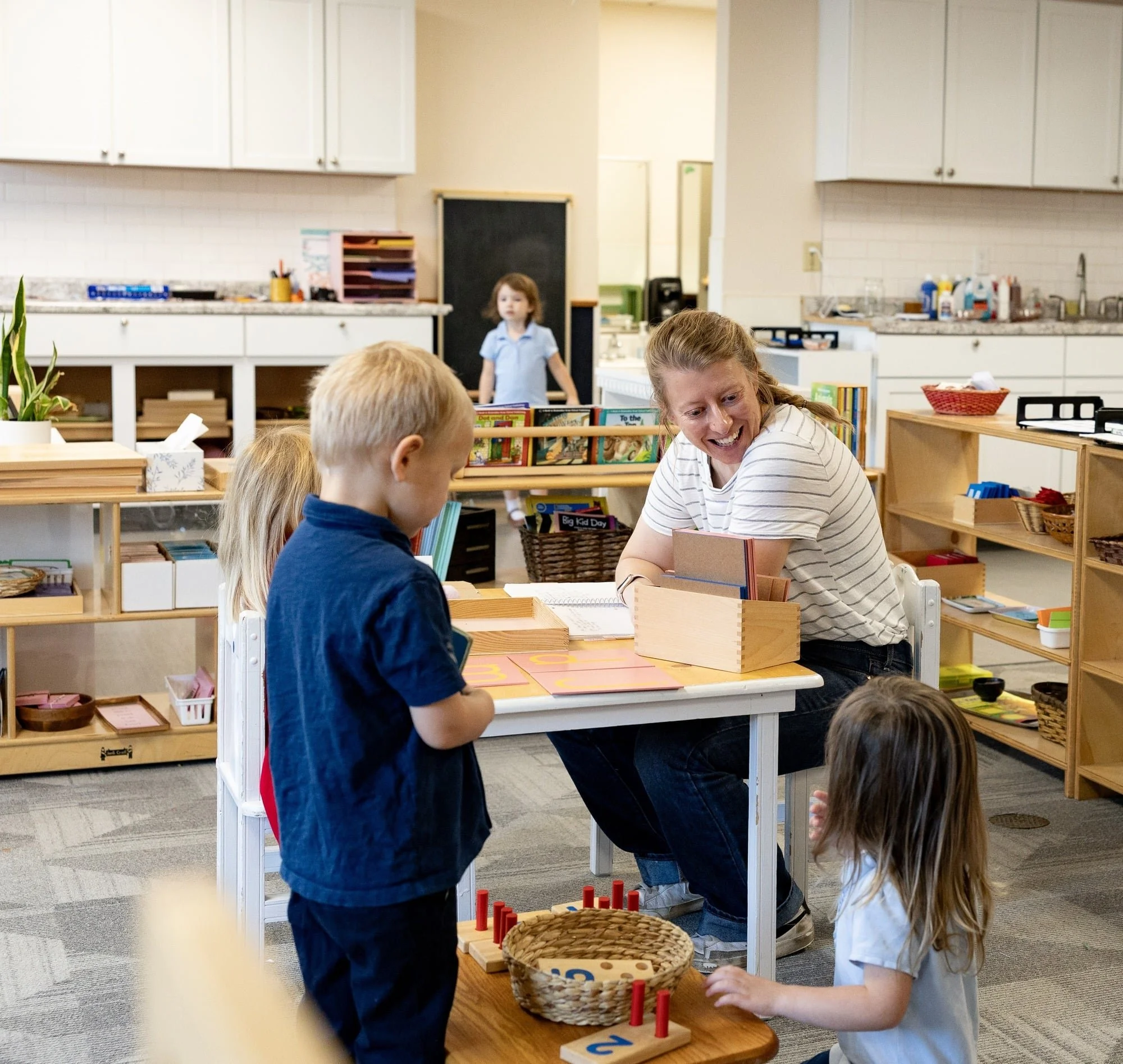 Children and teacher engaged in educational activities inside a classroom or library setting.