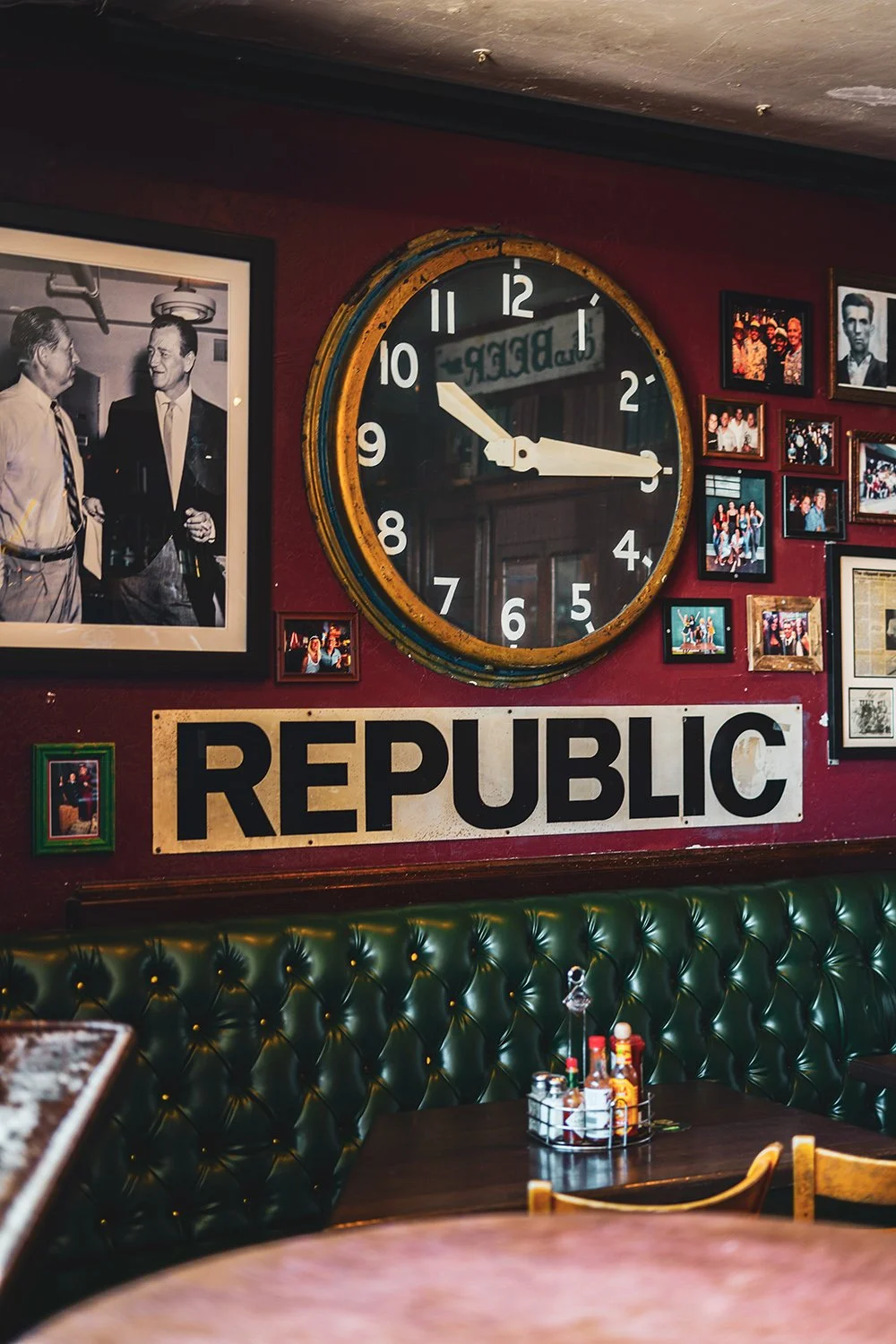 Wall clock showing 10:16 at a restaurant decorated with photos and a "REPUBLIC" sign.
